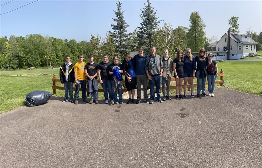 Image of JROTC Cadets standing in front of the memorial they spruced up as detailed in the story.